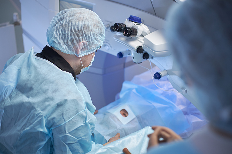A doctor performing cataract surgery on a patient